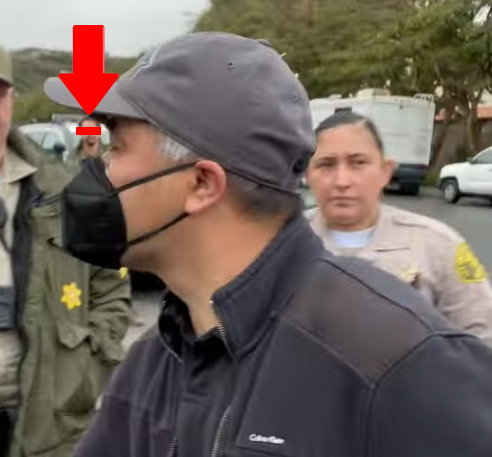 Photo allegedly showing Chora entering Malibu residence with sheriff personnel